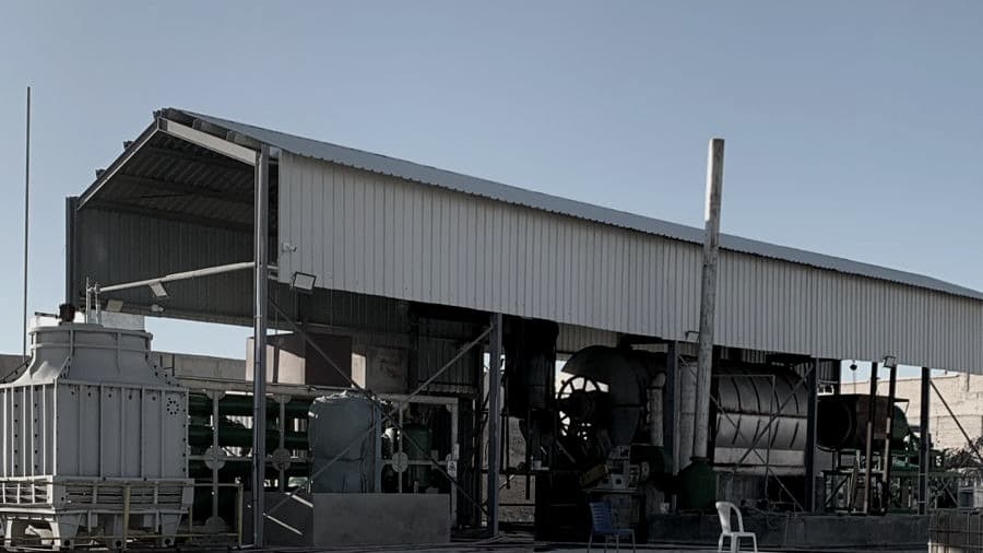 The ReMatter facility in Al-Hussain Industrial City, Al-Karak — reactor hall, cooling tower and condenser bank under the shed